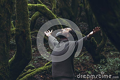 Spiritual zenlike nature love people. One man with closed eyes and outstretching arms in the nature forest green trees scenic Stock Photo