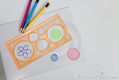 Spirograph ruler on white background. Drawing the spirograph pattern. Stock Photo