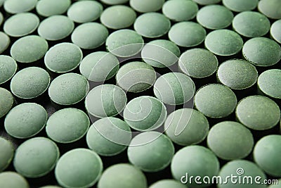 Spirulina tablets, closeup Stock Photo