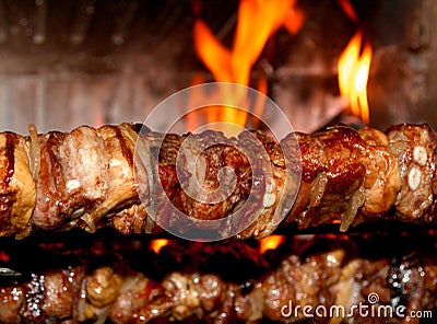 Spit roast with meat cooked on a spit in the fireplace 1 Stock Photo