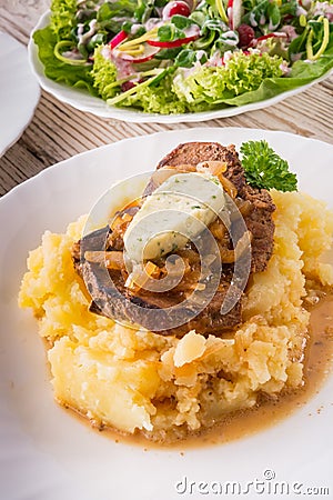 Spit roasts with braised onions Stock Photo