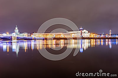 Spit Strelka of Vasilyevsky island with Rostral columns, Kunstkamera museum and Palace bridge at night during New Year and Chris Stock Photo
