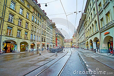 Spitalgasse street with colorful Pfeiferbrunnen fountainn and typical Bernese houses with arcades, on March 31 in Bern, Editorial Stock Photo