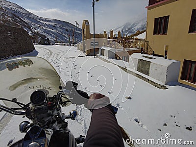Spiti, Himachal Pradesh, India - April 7th, 2021 : Winter landscape in a fabulous location, Bike riding in snow covered village in Editorial Stock Photo