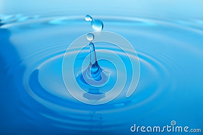 Splash of blue water with drop as background Stock Photo