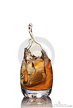 Splash in glass of scotch whiskey with ice cube Stock Photo