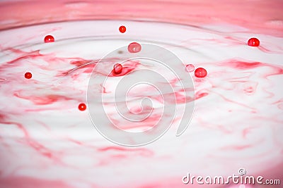 Splash of milk drop in pink color. Stock Photo