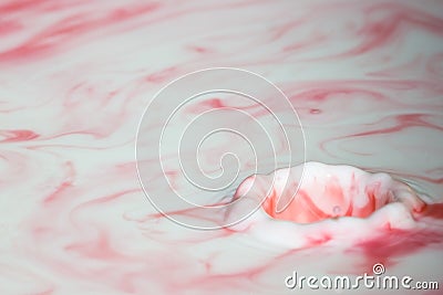 Splash of milk drop in pink color. Stock Photo