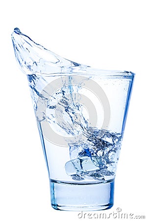 Splash of water in an elegant glass with ice isolated Stock Photo