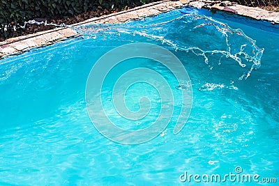 Splashing of disinfectant in outdoor swimming pool Stock Photo