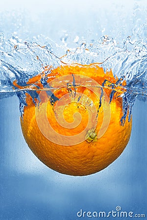 Splashing orange into a water Stock Photo