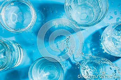 Splashing sparkling water in various glasses , summer drink concept Stock Photo