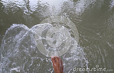 Splashing water with leg, splash water by leg Stock Photo