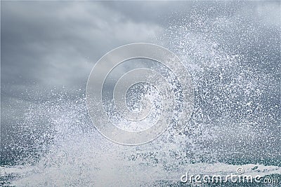 Splashing water of sea wave crashing on shore spraying white water foam Stock Photo