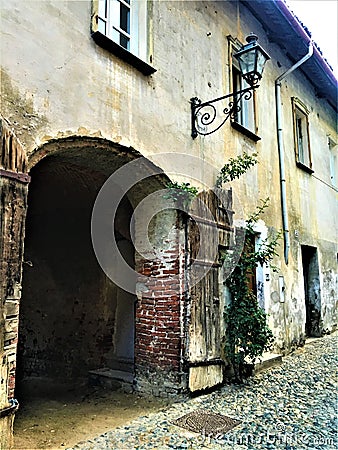 Splendid ancient door and wall in Saluzzo town, Piedmont region, Italy. History, enchanting architecture and art Stock Photo