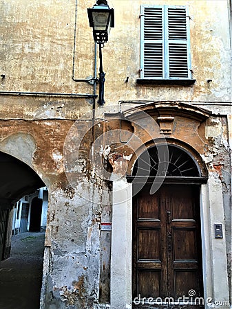 Splendid ancient door and wall in Saluzzo town, Piedmont region, Italy. History, enchanting architecture and art Stock Photo