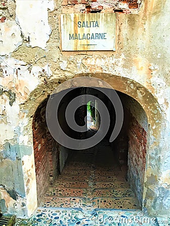 Splendid ancient door and wall in Saluzzo town, Piedmont region, Italy. History, enchanting architecture and art Stock Photo