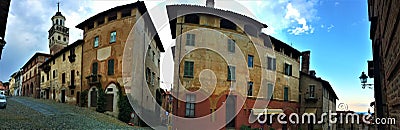 Splendid ancient street in Saluzzo town, Piedmont region, Italy. Colours, history, enchanting architecture and art Stock Photo