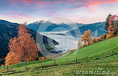 Splendid view of Zell lake. Impressive autumn sunrise of Austrian town - Zell am See, south of the city of Salzburg. Beauty of Stock Photo