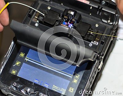 Splicing Fiber Optical Cable with Optical Fiber Fusion Splicer instrument professional tool Stock Photo