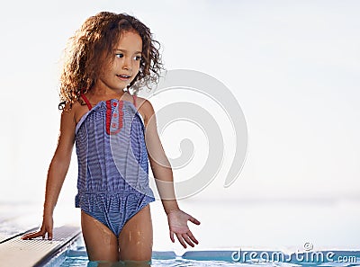 Splish Splash. a happy little girl playing in the pool. Stock Photo