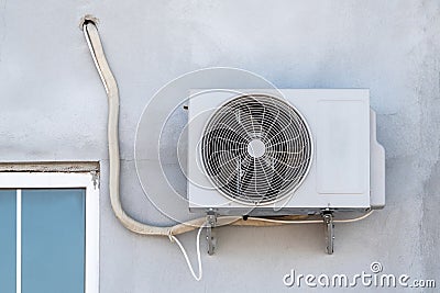 Split air conditioner outdoor unit. Air conditioning motor hanging on the outside wall Stock Photo