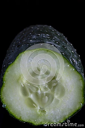 Split cucumber showing its inside and releasing its juice Stock Photo