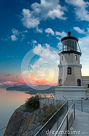 Split Rock Lighthouse Sunset with Moon Stock Photo