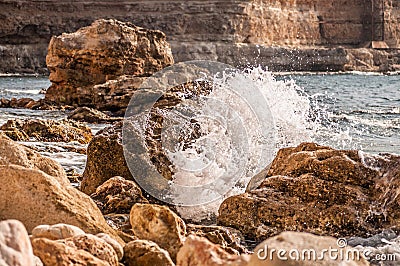 Splitting waves against picturesque rocks in the sea Stock Photo