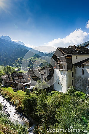 Picturesque mountain village with white stone houses and stone roofs in the Swiss Alps Editorial Stock Photo