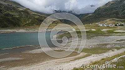 Spluegenpass with the Monte Spluga reservoir and surrounding mountains in summer Stock Photo