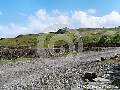 Spoil heap tips with greenery behind Stock Photo