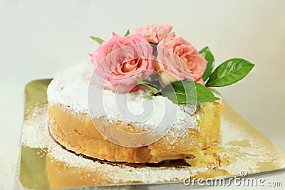 Sponge cake with icing decorated with real roses. Stock Photo