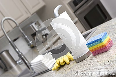 Sponges, paper towels, gloves, cloths in kitchen f Stock Photo
