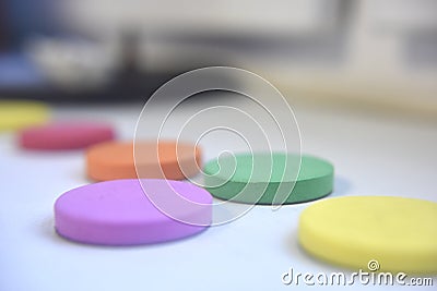 Spongy flat items of different colours on the white background indoor Stock Photo