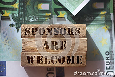 SPONSORS are WELCOME Know Your Worth on wooden blocks pur on 100 Euro banknotes. Sponsorship donation support business startup Stock Photo