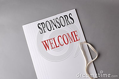 SPONSORS WELCOME text on white folder on grey background Stock Photo