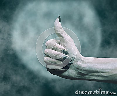 Dead hand with thumb up gesture in Halloween night. Stock Photo
