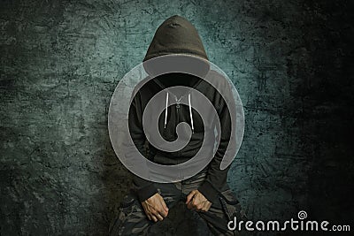 Spooky evil criminal person with hooded jacket Stock Photo
