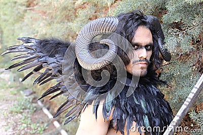 Spooky forest character with horns and wings Stock Photo