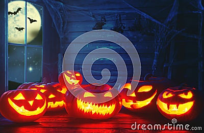 Spooky halloween background. scary pumpkin with burning eyes and Stock Photo