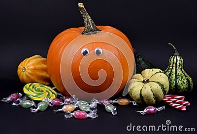 Spooky halloween pumpkin with eyes and candies stock images Stock Photo