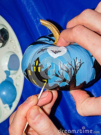 Spooky Halloween Scene Being Painted on Tiny Pumpkin Stock Photo