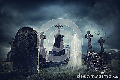 Spooky old graveyard and a ghost Stock Photo