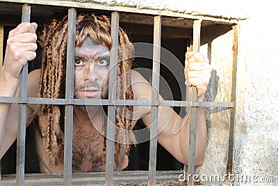 Spooky prisoner in trapped in a cell Stock Photo