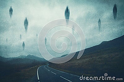 A spooky supernatural concept. Of spirits floating above a road in the mountains at night. With a grunge, textured edit Stock Photo