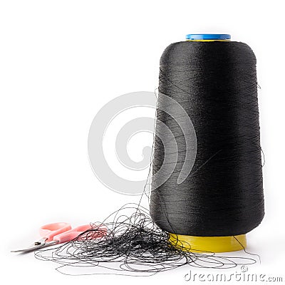 Spool of black sewing thread with a pair of scissors Stock Photo