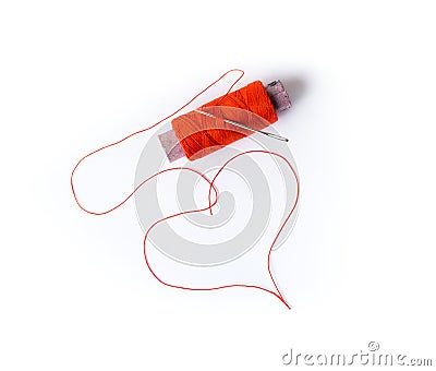 Spool with a needle and thread in the shape of heart Stock Photo