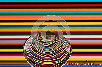 A spoon against a colorful background, showing the reflection of Stock Photo