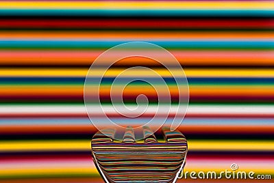 A spoon against a highly colored background, with the background Stock Photo